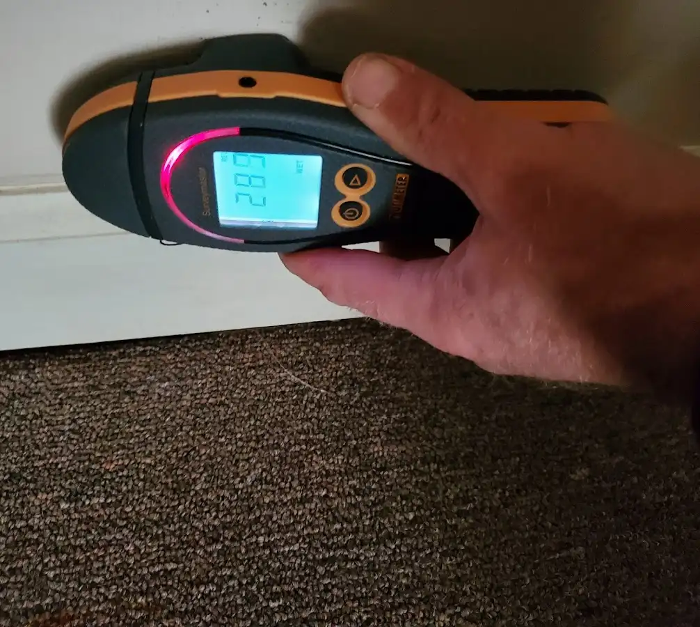Moisture detection at baseboard during Storm Damage Restoration in Magna